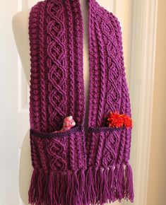 a purple scarf with fringes and flowers on it