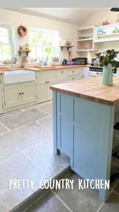 a kitchen with an island in the middle of it and lots of counter top space