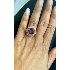 Amethyst, Pink Sapphire, and Diamond Cocktail Ring!  Playful yet Powerful! Its like having a piece of glittery candy on your finger! This ring has a Checkers Round Cut Amethyst that weighs 4.90 Carats and is embellished with alternating 12 Pink Sapphires that weigh 0.28 Carats and 12 Round Cut Diamonds that weigh 0.20 Carats. (Clarity: SI2, Color:F) The total carat weight of the ring is 5.38 Carats.  The ring is crafted in 14 Karat Yellow Gold and weighs approximately 4.8 grams. The ring is a si Fine Jewelry Amethyst Multi-stone, Luxury Purple Multi-stone Rings, Purple Diamond Gemstones With Accent Stones, Elegant Purple Ruby Ring Round Shape, Elegant Purple Ruby Ring Round Cut, Elegant Multi-stone Amethyst Promise Ring, Dazzling Amethyst Ring As A Gift, Dazzling Amethyst Ring Gift, Dazzling Amethyst Gift Ring