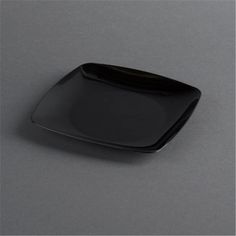 a black square plate sitting on top of a table