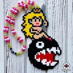 a piece of art made to look like an old video game character with beads around it