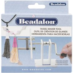 beadalon tassel maker tool with beads and tassels on it