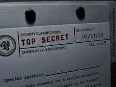 the top secret identification card is posted on an electronic device's back side,