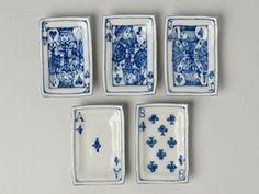 four blue and white plates with designs on them