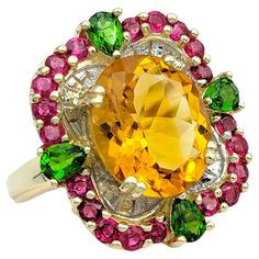 Ring Size: 6.5 This stunning ring showcases a vibrant blend of gemstones set in 14 karat yellow gold, creating a captivating and colorful design. At its center is a large oval citrine, radiating warmth and brilliance. Surrounding the citrine is a halo of round rubies, adding a rich contrast of color and depth to the piece. Accentuating the design are pear-shaped peridot stones, which enhance the ring's overall aesthetic with their fresh green hue. The combination of citrine, rubies, and peridot creates a dynamic and eye-catching composition, making this ring a unique and stylish accessory for any occasion. With its bright colors and elegant design, it's sure to be a standout addition to any fine jewelry collection. This piece is in very good estate condition and has been professionally cle Glamour Jewelry, Red Topaz, Peridot Color, Ring Ruby, Citrine Jewelry, Gift Suggestions, Sterling Silver Bangle Bracelets, Jewelry Post, Gold Gemstone Ring