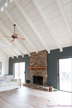 a living room filled with furniture and a fire place in the middle of a room