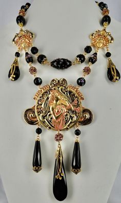 Stunning black & Pink Art Nouveau Lady Necklace, Gold plated with hand painted patina, Onyx and vintage Czech glass drops, Facetted Onyx beads, Gorgeous Lampwork Venetian wedding cake & Czech beads, Vintage Swarovski rhinestone beads, Facetted crystal beads, hand beaded chain, signed CZECHO top metal components, 1920s Czech bead caps, lobster clasp with hand closure, Absolutely Frivolous tag and extender chain. Handmade Black Enamel Necklace, Ornate Handmade Black Necklace, Black Hand Painted Pendant Jewelry, Hand Painted Black Pendant Jewelry, Vintage Black Hand Painted Jewelry, Vintage Black Hand-painted Jewelry, Artistic Black Enamel Jewelry, Black Jewelry With Artistic Design, Black Artistic Jewelry