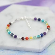 This beautiful rainbow gemstone bracelet has 7 different gemstones; one linking to each chakra.   The gemstones are 4 - 5mm in size and separated by sterling silver beads.  Each set of chakra gemstones is separated by two sterling silver stardust beads. Each bracelet measures 7 inches in length with a 1 inch extension chain, and comes with a little printed card with the names and properties of the crystals. This chakra bracelet is also available in gold fill - https://www.etsy.com/uk/listing/734 Rainbow Gemstone Beads Bracelets For Jewelry Making, Multicolor Natural Stones Bracelet In Sterling Silver, Multicolor Sterling Silver Bracelet With Natural Stones As Gift, Multicolor Sterling Silver Bracelet With Natural Stones, Adjustable Multicolor Sterling Silver Bracelet With Natural Stones, Multicolor Gemstone Beads Bracelet In Sterling Silver, Multicolor Sterling Silver Gemstone Bead Bracelets, Spiritual Rainbow Bracelets For Jewelry Making, Multicolor Gemstone Beads Sterling Silver Bracelets