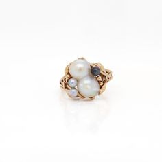 A fine signed baroque pearl ring.  In 14k yellow gold.  By the renowned Ming's Jewelry Company of Honolulu, Hawaii, San Francisco, and New York.  Center-set with a remarkable baroque double pearl flanked by black & grey pearls.  In a split band setting with leaf and vine work decoration.  Bearing an etched signature to the underside for Ming's / 14k .  Simply a wonderful Baroque pearl ring!  Date: 20th Century  Overall Condition: It is in overall good, as-pictured, used estate condition.   Condi Pearl Cluster Ring, Bespoke Rings, Pearl Cluster, Honolulu Hawaii, Pearl Grey, Jewelry Companies, Baroque Pearls, Cluster Ring, Pearl Ring