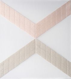 the corner of a white wall with pink and beige strips on it