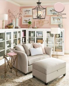 a living room with pink walls and white furniture in it's centerpieces