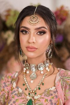 a woman wearing an elaborate necklace and earrings