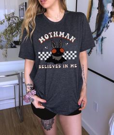 Let everyone know that Mothman Believes in You, in this adorable vintage-style Mothman t-shirt. Perfect for anyone interested in cryptids and Mothman lore.  Want a different design or color? Just let us know and we'll make it happen!  FIT & SIZING: * These soft and lightweight Bella-Canvas unisex t-shirts have just the right amount of stretch, and are made in the USA. * Tees are comfortable and flattering for both men and women. * Please see the size chart in the photos to obtain an accurate size. Measure one of your favorite tees for comparison! * Ladies: These tees are unisex sizes. Your normal size will fit a bit loosely. For a snug fit, order one size down from your normal size. For an oversized fit, size up.  * Though rolled up in some product pictures, sleeves will not come rolled up Fandom Crew Neck Shirt With Screen Print, Pre-shrunk Crew Neck Grunge Shirt, Pre-shrunk Grunge Crew Neck Shirt, Grunge Style Pre-shrunk Crew Neck Shirt, Halloween Fandom Short Sleeve Tops, Fandom Halloween Short Sleeve Tops, Supernatural Shirt, Usa Tee, Work Shirts