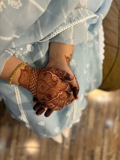 a woman's hand with henna on it