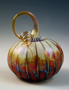 a glass vase with an artistic design on it