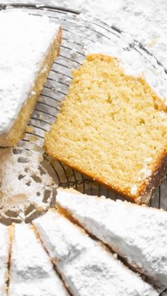 a piece of cake sitting on top of a cooling rack with powdered sugar around it