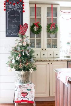 a decorated christmas tree in a kitchen