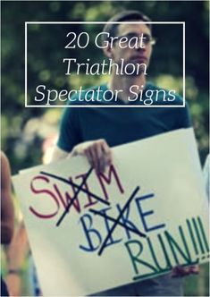 a man holding a sign with the words swim bake run written on it in front of him