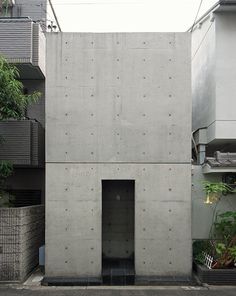 a concrete building with an open door on the side