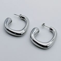 Update your look with these bold Tubi Chunky Geometric Hoop Earrings. The chunky design effortlessly adds a touch of glamour to any outfit, while the geometric shape adds a modern edge. These earrings are sure to make a statement and elevate your style to the next level. Geometric Hoop Earring Stainless steel metal Sensitive skin-friendly 37 mm * 32 mm Light weight Available in gold and silver Modern Small Hoop Earrings, Modern Chunky Hoop Earrings, Modern Chunky Metal Earrings, Modern Small Hoop Metal Earrings, Chic Chunky Earrings, Chunky Metal Hoop Earrings Modern Style, Modern Chunky Metal Hoop Earrings, Trendy Chunky Hoop Earrings, Modern Chunky Hoop Earrings For Everyday