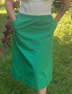 Women's Vintage 1970's Grass Green Knee Length Skirt *Size Large* $40 Handmade and so comfortable! The skirt is simple yet striking. I replaced the elastic waistband with a new one. The skirt has pockets! Belt loops for a matching belt that is included (though I had a hard time getting the belt into the loops?)! This skirt screams, Saint Patrick's Day to me but she is also ready for Spring and warmer days! Waist: 30"-32" Skirt Length: 27" from waistband to hem Fabric: 100% cotton Clothing Care: Hand wash and flat dry. Retro Skirted Cotton Bottoms, Summer Retro Solid Color Skirt, Retro Solid Bottoms With Lined Skirt, Vintage Solid Color Lined Skirt, Green Lined Skirt For Daywear, Retro Solid Color Skirt For Spring, Vintage Green Skirt With Pockets, Retro Green Long Skirt Bottoms, Retro Green Long Skirt