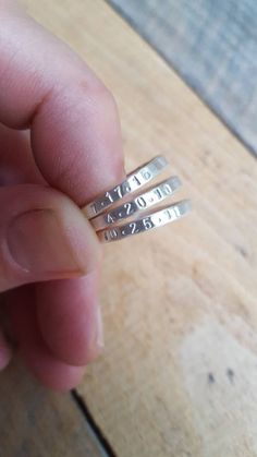 "These stacking name rings are hand stamped with the name of your choice. I form these rings from thick wire in the metal of your choice (sterling silver or 14K gold) and then hammer them to size. It leaves them with a subtle hammered finish. I then hand stamp the names onto the rings. They are skinny yet thicker than some of my other name rings and are about 2mm wide. In the photos, the rings have a matte finish, but they can also have a shiny or brushed finish. I wear a stack of these around m Sterling Silver Engraved Name Ring For Anniversary, Personalized Silver Ring With Meaningful Style, Personalized Sterling Silver Stackable Rings For Anniversary, Sterling Silver Engraved Name Promise Ring, Customizable Adjustable Sterling Silver Engraved Ring, Adjustable Customizable Engraved Sterling Silver Ring, Sterling Silver Rings With Names For Anniversary, Personalized Adjustable Ring For Anniversary, Adjustable Personalized Rings For Anniversary