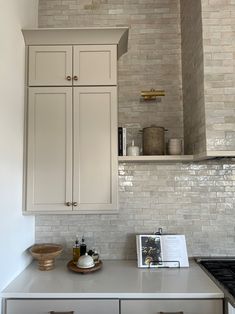 a kitchen with white cabinets and an oven