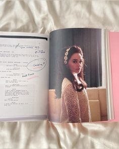 an open book with a woman's profile and handwritten text on the page