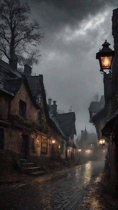 an old fashioned street with cobblestone streets and houses on either side at night