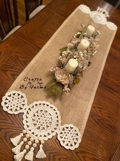 a table runner with candles and flowers on it