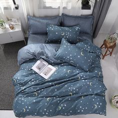 a bed with blue sheets and stars on it