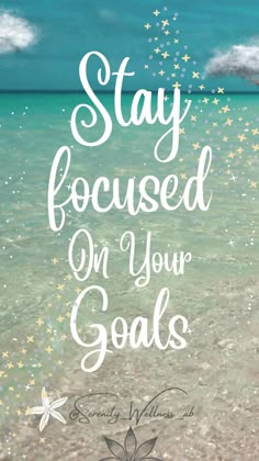 the words stay focused on your goals are written in white ink and surrounded by stars