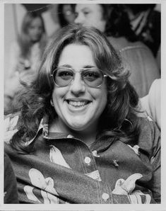 black and white photograph of woman with glasses smiling