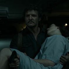 a man holding a woman in the dark