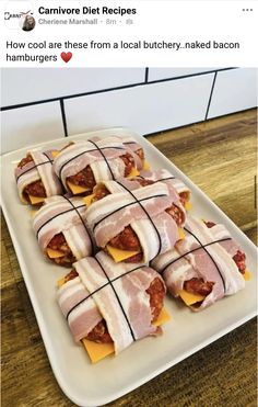 food wrapped in bacon and cheese on a white plate next to a wooden counter top