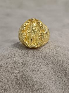 Gold Virgen Milagrosa Miraculous Ring, 10k 14k 18k Solid Gold Women's Ring, Virgen de Guadalupe Ring, Unique Gold Religious Gift for Women ★Item Details * Gender : Female / Male  * Material: 10K - 14K - 18K Gold * Ring Diameter: 1.9cm (0.8 inches)  * Ring Weight:  10K: 10.50 - 11.00 Gr 14K: 11.50 - 12.00 Gr 18K: 12.50 - 13.00 Gr * All our products are handmade and weights may vary   (-) 1,00 gram  * Ring Size: 5 US to 15 US - ( Contact me if you're expecting to buy another ring size ) * Visit our shop for more items https://www.etsy.com/shop/7SAtelier  ✔ Ready to Ship in 3-5 Business Days ✔ Free shipping worldwide! ✔ The product will be sent in a bubble-wrapped handmade wooden box to avoid any damage during shipping. ✔ Visit our store, browse our other collections, and find the perfect pie Gold Spiritual Signet Ring For Ceremonial Occasions, Spiritual 14k Gold Oval Signet Ring, Traditional Gold Oval Signet Ring, Spiritual Oval Engraved Ring In Yellow Gold, Spiritual Hallmarked Yellow Gold Rings, Spiritual Yellow Gold Engraved Oval Ring, Spiritual Engraved Oval Yellow Gold Ring, Spiritual Oval Engraved Yellow Gold Ring, Spiritual Engraved Yellow Gold Oval Ring