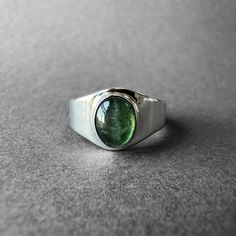 Natural Green Tourmaline Silver Ring - Green Chrome Tourmaline Ring Size 7 - Completely Handmade & Silver Gemstone: Green Tourmaline ( Chrome Tourmaline )  Metal: Pure and 925 Sterling Silver Stone Cut: Cabochon Stone Size: 8.5 mm x 6.9 mm - 0.33 in - 0.27 in Weight: 4.6 grams (23 carats) total weight of stone and silver. For ring orders, ring resizing is free. Chains are gifts for necklace orders..  Note: We don't use any filters for photos. The details may not be clear. Feel free to contact us Classic Green Tourmaline Jewelry, Silver Tourmaline Emerald Ring, Classic Oval Tourmaline Jewelry, Classic Tourmaline Jewelry With Polished Finish, Silver Tourmaline Birthstone Ring With Gemstone, Tourmaline Birthstone Rings For May, Silver Tourmaline Cabochon Ring, Silver Cabochon Tourmaline Ring, Silver Tourmaline Ring With Polished Finish