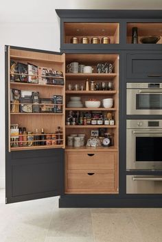 an open cabinet in the middle of a kitchen