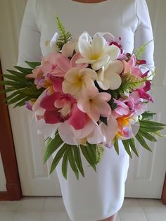 a woman holding a bouquet of flowers in her hands