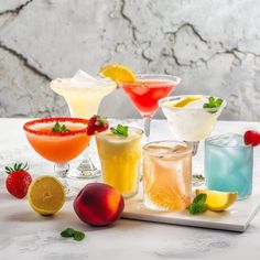 several different types of cocktails on a tray