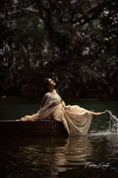 a woman sitting on top of a boat in the water