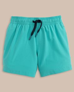 The front view of the Southern Tide Boys Solid Swim Truck 2 0 by Southern Tide - Tidal Wave Green Swim Trunks With Upf 50+ For Vacation, Solid Nylon Swim Trunks For Beach Season, Short Length Swim Trunks With Upf 50+ For Pool, Solid Color Beachwear Shorts With Upf 50+, Solid Color Swim Trunks For Poolside And Beach, Beachwear Shorts With Upf 50+, Green Summer Swim Trunks For Pool, Solid Color Upf 50+ Beachwear Shorts, Upf 50+ Short Swim Trunks For Pool