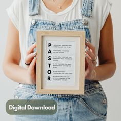 a woman holding up a framed poster with the words paastor written in it