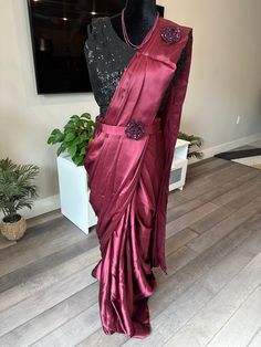 This 1 min saree is already stitched and as the name suggests, can be draped in just a min :). The fabric of the saree is a very soft and flowy satin silk and the pallu and pleats are already made. Hooks are provided to hook the pleats in and the saree comes with a sequin work fully stitched blouse that is side open with zipper. The blouse is sleeveless but comes with sleeves inside that can be attached on request. Shade of the saree is a oil red and blouse is black shade. Great for evening part 1 Minute Saree, Blouse Party Wear, Party Wear Sarees Online, Embroidered Kurti, Organza Dupatta, Black Shade, Work Sarees, Silk Sarees Online, Valentines Day Gifts For Her