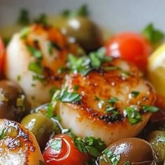 scallops with olives, tomatoes and lemon in a bowl