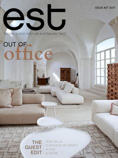 a magazine cover with white couches and pillows