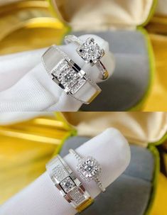 two wedding rings sitting on top of each other in front of a yellow and white box