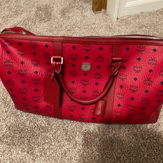 Mcm Travel Bag For Men And Women Like New Only Used Once Red Tote Travel Bag For Everyday Use, Red Weekender Bag With Leather Handles For Everyday, Red Large Capacity Shoulder Bag For Business, Large Capacity Red Shoulder Bag For Business, Red Travel Bag With Luggage Sleeve, Designer Red Bags With Leather Trim, Red Top Handle Business Bag, Luxury Red Travel Bag For Everyday Use, Red Top Handle Bag For Business