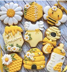 decorated cookies are arranged in the shape of honeycombs and beehives with daisies