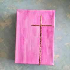 a pink book with a cross painted on it